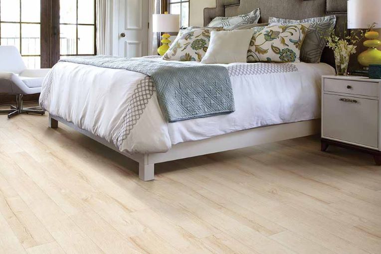 light wood look laminate flooring in a bright bedroom